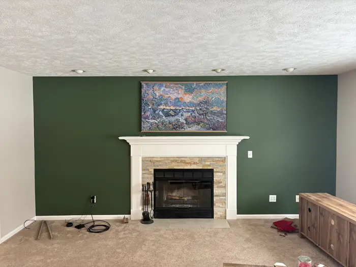 Deep green fireplace wall with white mantel